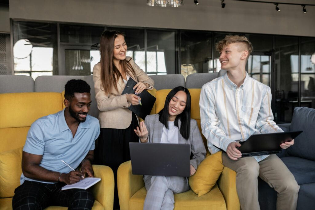 A group of English language tutoring students gather to discuss a project.